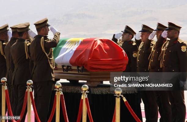 Honour guards salute next to the coffin of Iraqi ex-president Jalal Talabani during a ceremony at the airport in the Iraqi Kurdish city of...