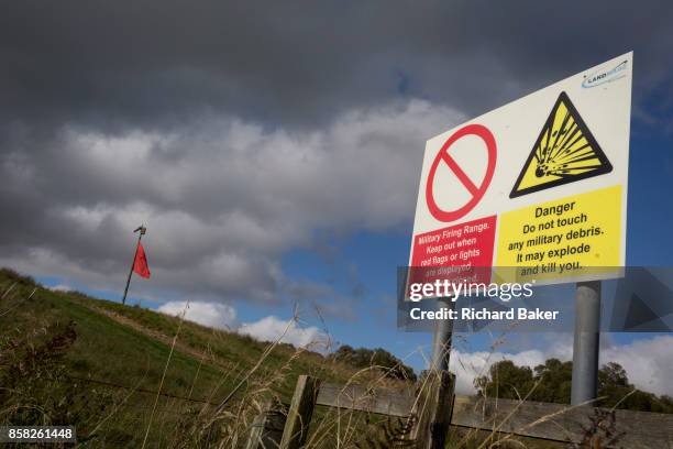 Red warning flag flies on the perimeter during military live firing at Otterburn Ranges, on 28th September 2017, in Otterburn, Northumberland,...