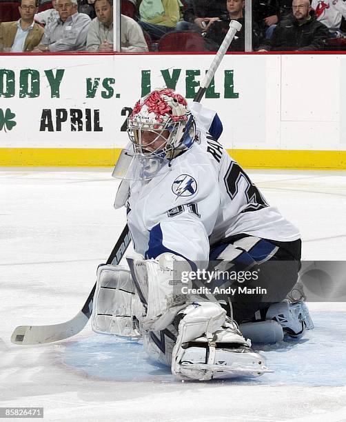 Karri Ramo of the Tampa Bay Lightning defends against the New Jersey Devils at the Prudential Center on April 3, 2009 in Newark, New Jersey. The...