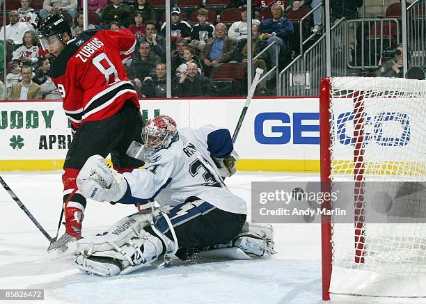 Karri Ramo of the Tampa Bay Lightning looks behind him as the puck rings off the post against the New Jersey Devils at the Prudential Center on April...