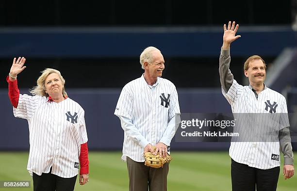 Airways crew member Doreen Welsh, pilot, Captain Chesley "Sully" Sullenberger and co-pilot Jeffrey Skiles take the field prior to the game between...