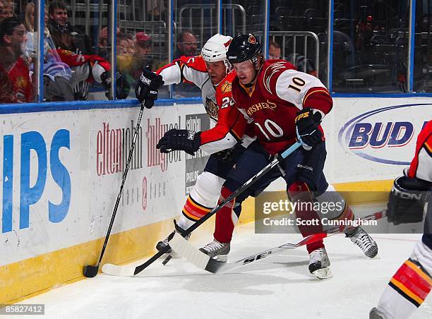 Bryan Little of the Atlanta Thrashers battles for the puck against Jassen Cullimore of the Florida Panthers at Philips Arena on March 3, 2009 in...