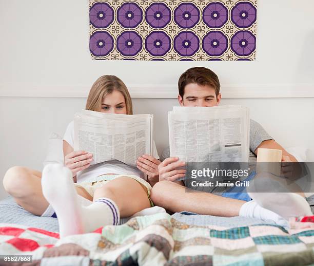 couple in bed with newspapers - read and newspaper and bed stock pictures, royalty-free photos & images