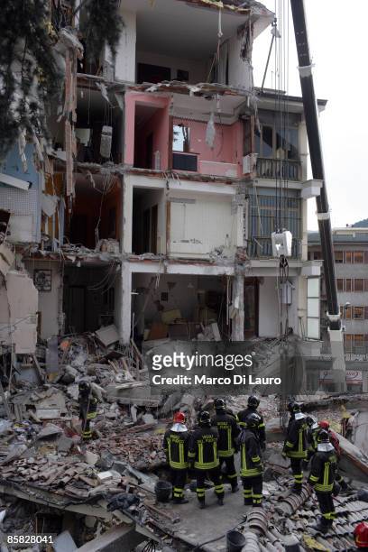 Rescue workers search for trapped people on a damaged building after an earthquake on April 6, 2009 in L'Aquila, Italy. The 6.3 magnitude earthquake...