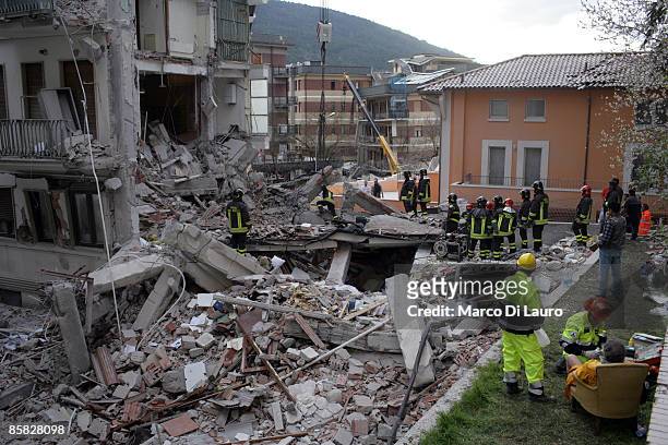 Rescue workers search for trapped people on a damaged building after an earthquake on April 6, 2009 in L'Aquila, Italy. The 6.3 magnitude earthquake...