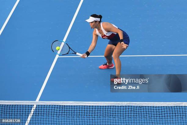 Yung-Jan Chan of Chinese Taipei returns a shot against Gabriela Dabrowski of Canada and Yifan Xu of China during their Women's Doubles Quarterfinals...