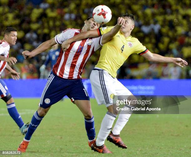 Santiago Arias of Colombia struggles for the ball with Angel Romero of Paraguay during a match between Colombia and Paraguay as part of FIFA 2018...