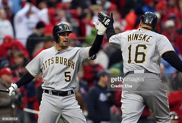 Eric Hinske of the Pittsburgh Pirates is congratulated by teammate Ramon Vazquez after Hinske scored in the 9th inning against the St. Louis...