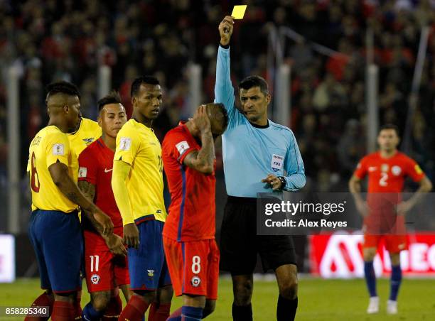 Referee Sandro Ricci shows a yellow card to Arturo Vidal of Chile during a match between Chile and Ecuador as part of FIFA 2018 World Cup Qualifiers...