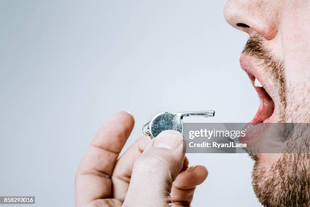 whistle blowing man sounding the alarm - whistle blowing stock pictures, royalty-free photos & images