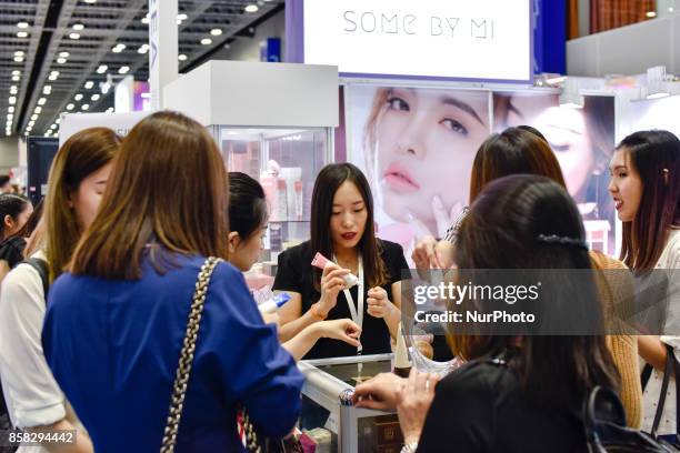 South Korean exhibitor is explaining cosmetics to buyers during the Beauty Expo 2017 on October 6, 2017 at Kuala Lumpur Convention Centre, Malaysia....
