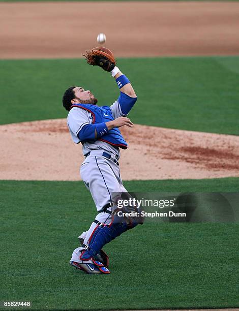 Catcher Russell Martin of the Los Angeles Dodgers catches a popup hit by Adrian Gonzalez of the San Diego Padres in the fourth inning on Opening Day...