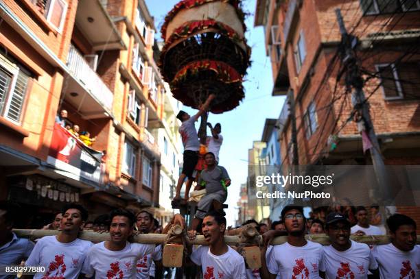 Locals carry as well as rotates top part of a chariot of Lord Narayan across the streets of Hadigaun during Lord Narayan jatra festival in Hadigaun,...