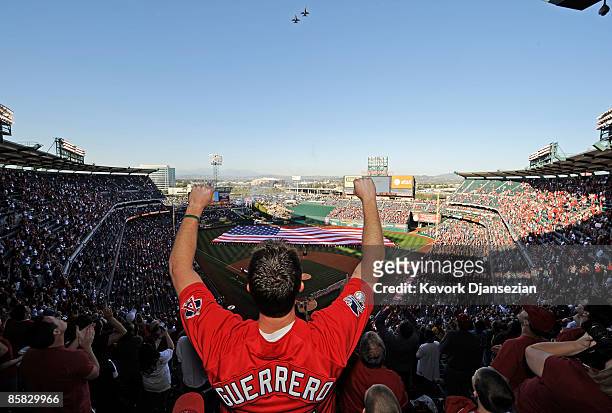 Fan celebrates after the national anthem during Los Angeles Angels opening day ceremonies against the Oakland Athletics at the Angels Stadium of...