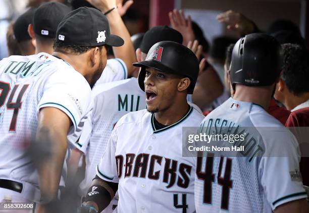 Ketel Marte of the Arizona Diamondbacks celebrates with teammate Yasmany Tomas after scoring on a three run home run by Paul Goldschmidt in the first...