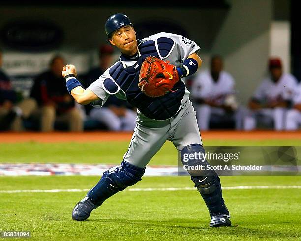 Kenji Johjima of the Seattle Mariners picks up a bunt by Denard Span of the Minnesota Twins and throws him out on Opening Day at the Metrodome on...