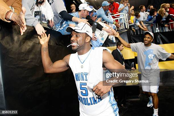 Ty Lawson and Wayne Ellington of the North Carolina Tar Heels celebrate with fans as they run off the court after the Tar Heels 89-72 win against the...