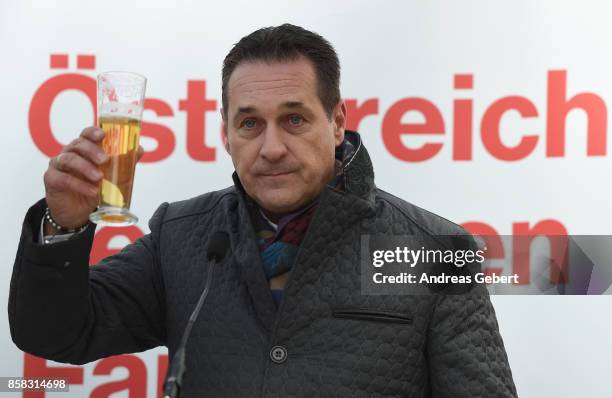 Heinz-Christian Strache of the right-wing Austria Freedom Party drinks beer after speaking to supporters at an election campaign rally on October 6,...