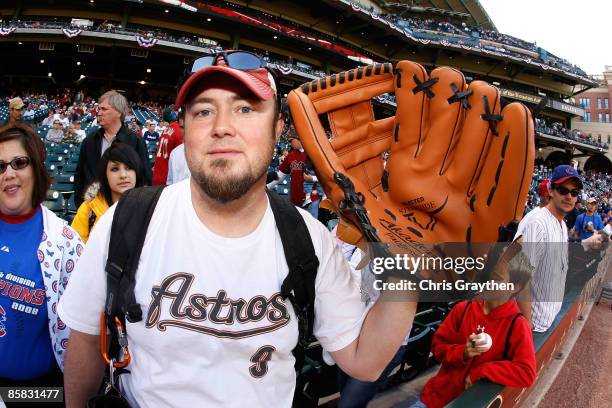 Fan holds up a giant baseball glove before a game between the Chicago Cubs and the Houston Astros on Opening Day on April 6, 2009 at Minute Maid Park...