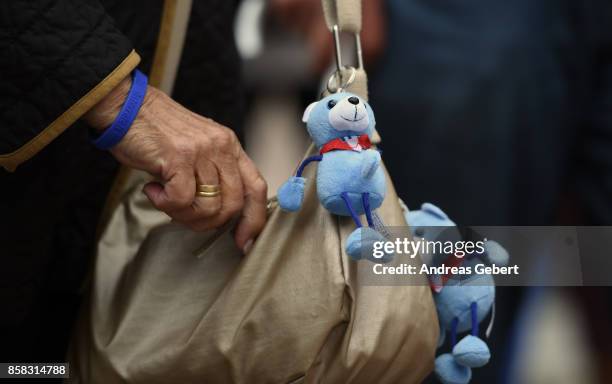 Two teddy bears of the right-wing Austria Freedom Party are attached to a woman's purse at an election campaign rally on October 6, 2017 in...