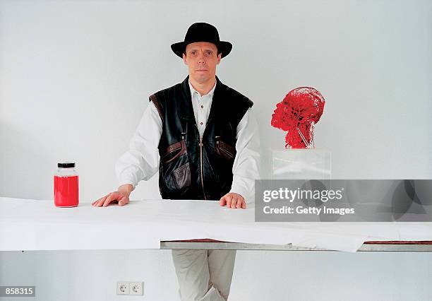 Professor Gunter Von Hagens stands next to one of his anatomical specimens March 20, 2002 at The Atlantis Gallery in the Old Truman Brewery in...