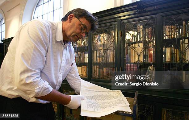 Curator of the State Library of NSW, Stephen Martin handles a carbon copy of the original Schindler's List following its discovery by The State...