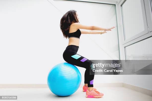 young brunette doing pilates at home - yoga ball fotografías e imágenes de stock