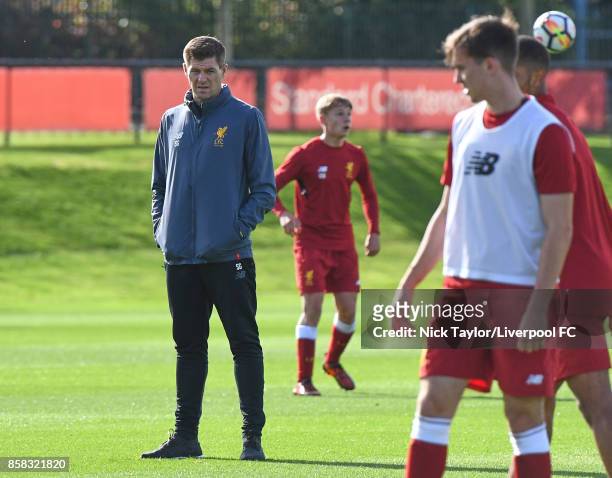 Liverpool U18 manager Steven Gerrard watches his players warm up before the U18 friendly match between Liverpool and Burnley at The Kirkby Academy on...
