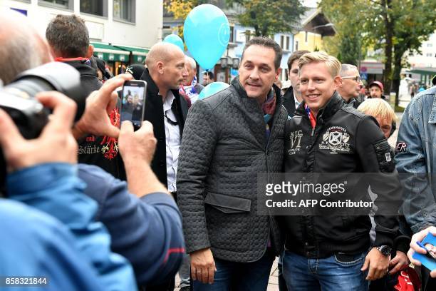 Heinz-Christian Strach, the chairman of the far-right Freedom Party of Austria , poses for pictures with supporters during a campaign meeting on...
