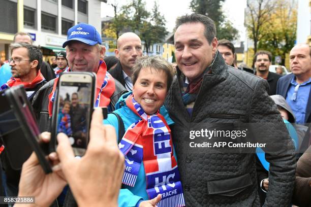 Heinz-Christian Strach, the chairman of the far-right Freedom Party of Austria , poses for pictures with supporters during a campaign meeting on...