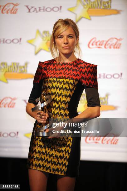 Supporting Actress of the Year Sienna Miller poses for photos in the press room at ShoWest 2009's Final Night Banquet And Award Ceremony on April 2,...