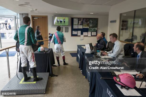 Jamie Spencer and Frankie Dettori watch a replay in the weighing room before being called into a stewards enquiry at Ascot racecourse on October 6,...