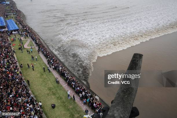 Visitors crowd to watch the soaring tide of the Qiantang River at Yanguan Ancient Town on October 6, 2017 in Jiaxing, Zhejiang Province of China....