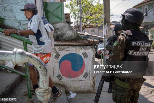 Brazilian Armed Forces soldiers patrol the Morro dos Macacos favela in Rio de Janeiro, Brazil on October 6, 2017. Security officials said the Morro...