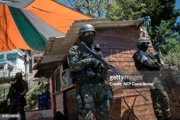 Brazilian Armed Forces soldiers patrol the Morro dos Macacos favela during a security operation in the area in Rio de Janeiro, Brazil on October 6,...