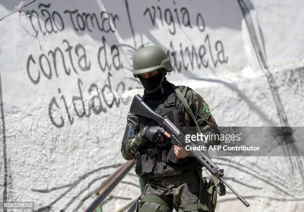 Brazilian Armed Forces soldier patrols the Morro dos Macacos favela during a security operation in the area in Rio de Janeiro, Brazil on October 6,...