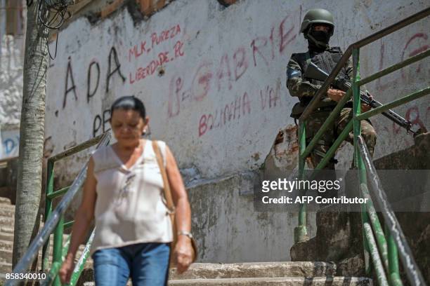 Brazilian Armed Forces soldier keeps watch at the Morro dos Macacos favela during a security operation in the area in Rio de Janeiro, Brazil on...