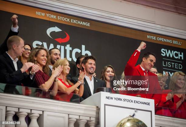 Rob Roy, founder and chief executive officer of Switch Inc., center, rings the opening bell before the company's initial public offering on the floor...