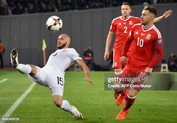 Georgia's midfielder Valeri Gvilia, Wales' defender Chris Gunter and Wales' midfielder Aaron Ramsey vie for the ball during the FIFA World Cup 2018...