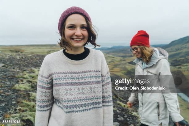 Two women walking near Haifoss  valley in mountains