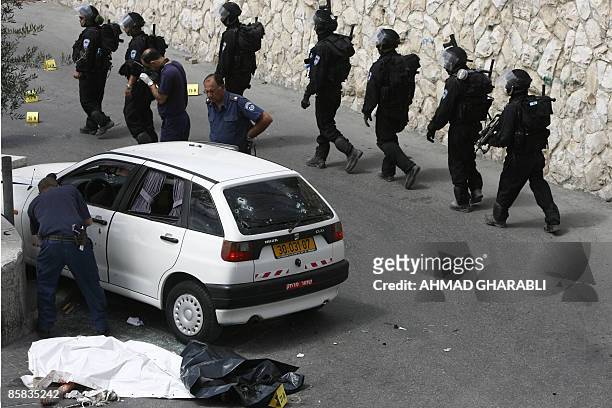 Israeli Police inspect on April 7, 2009 the scene where a Palestinian man was killed by Israeli fire after he tried to drive into a checkpoint near...