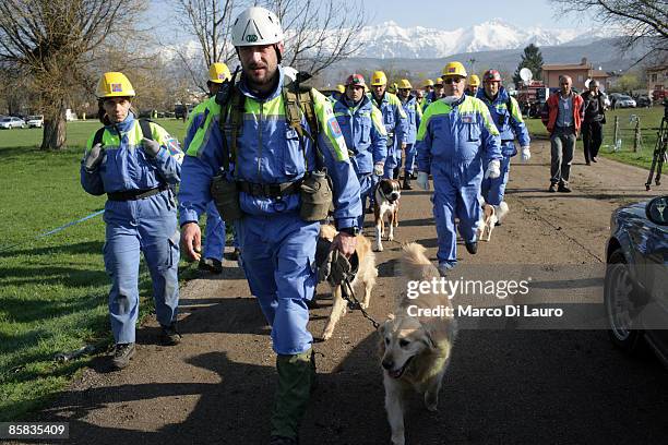 Rescue workers with search and rescue dogs are seen at work on April 7, 2009 in Onna a village near L'Aquila, Italy. On April 6, 2009 the 6.3...