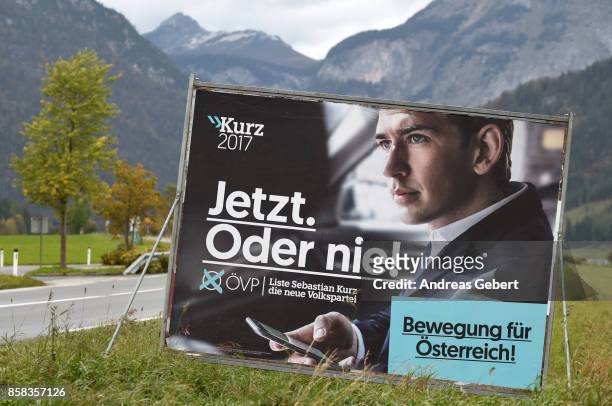 An election campaign poster of Sebastian Kurz of the conservative party stands next to a road in front of the mountains on October 6, 2017 near...
