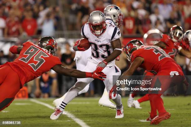 New England Patriots running back Dion Lewis attempts to break a tackle from Tampa Bay Buccaneers defensive back Robert McClain and Tampa Bay...