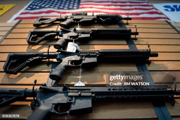 Assault rifles hang on the wall for sale at Blue Ridge Arsenal in Chantilly, Virginia, on October 6, 2017.