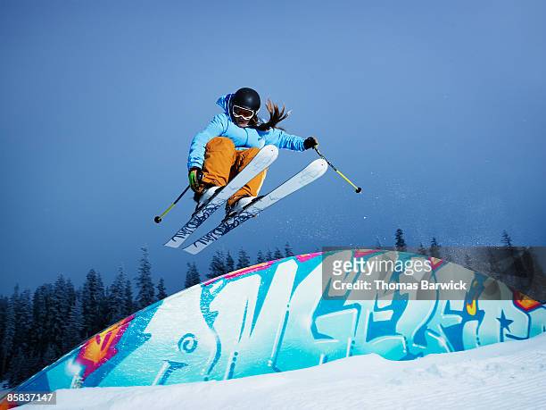 female skier jumping over a rainbow box - freestyle skiing bildbanksfoton och bilder