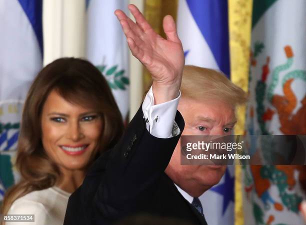 President Donald Trump and first lady Melania Trump depart from an event to celebrate Hispanic Heritage Month in the East Room at the White House, on...