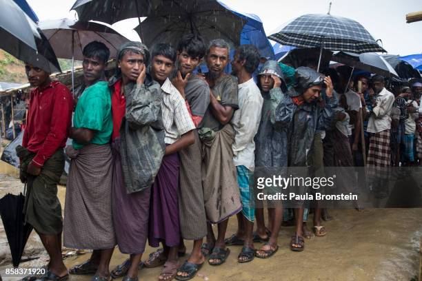 Rohingya men wait in line for UNHCR distribution at the Kutupalong camp October 6, Kutupalong, Cox's Bazar, Bangladesh. Over a half a million...