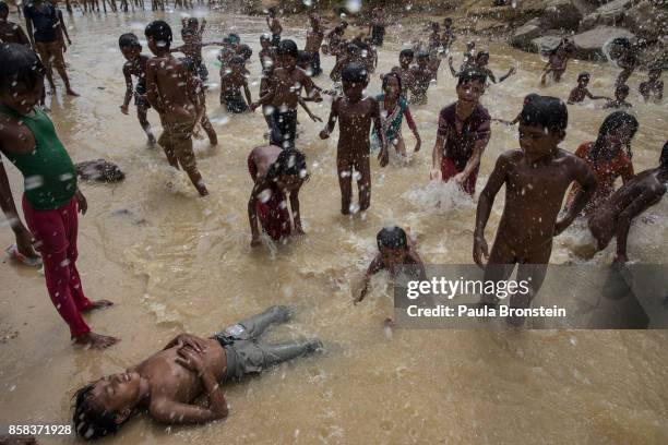 Children play in the dirty water in a small stream that runs through the Kutupalong camp October 6, Kutupalong, Cox's Bazar, Bangladesh. Over a half...