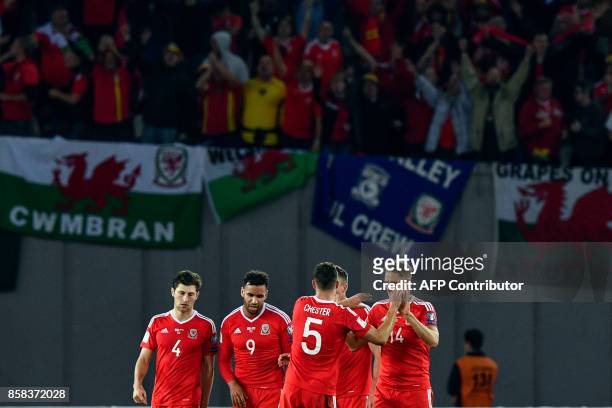 Wales' players celebrate after the FIFA World Cup 2018 qualification football match between Georgia and Wales in Tbilisi on October 6, 2017. / AFP...